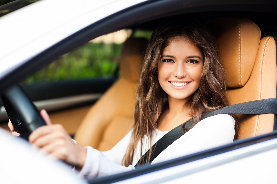 Girl Holding Steering Wheel Smiling with Auto Insurance in Moultrie, GA, Tifton, Albany, GA, Valdosta, Sylvester, GA